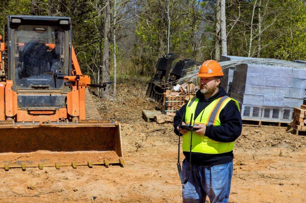 Using drone, construction inspector checks quality of construction at a construction site